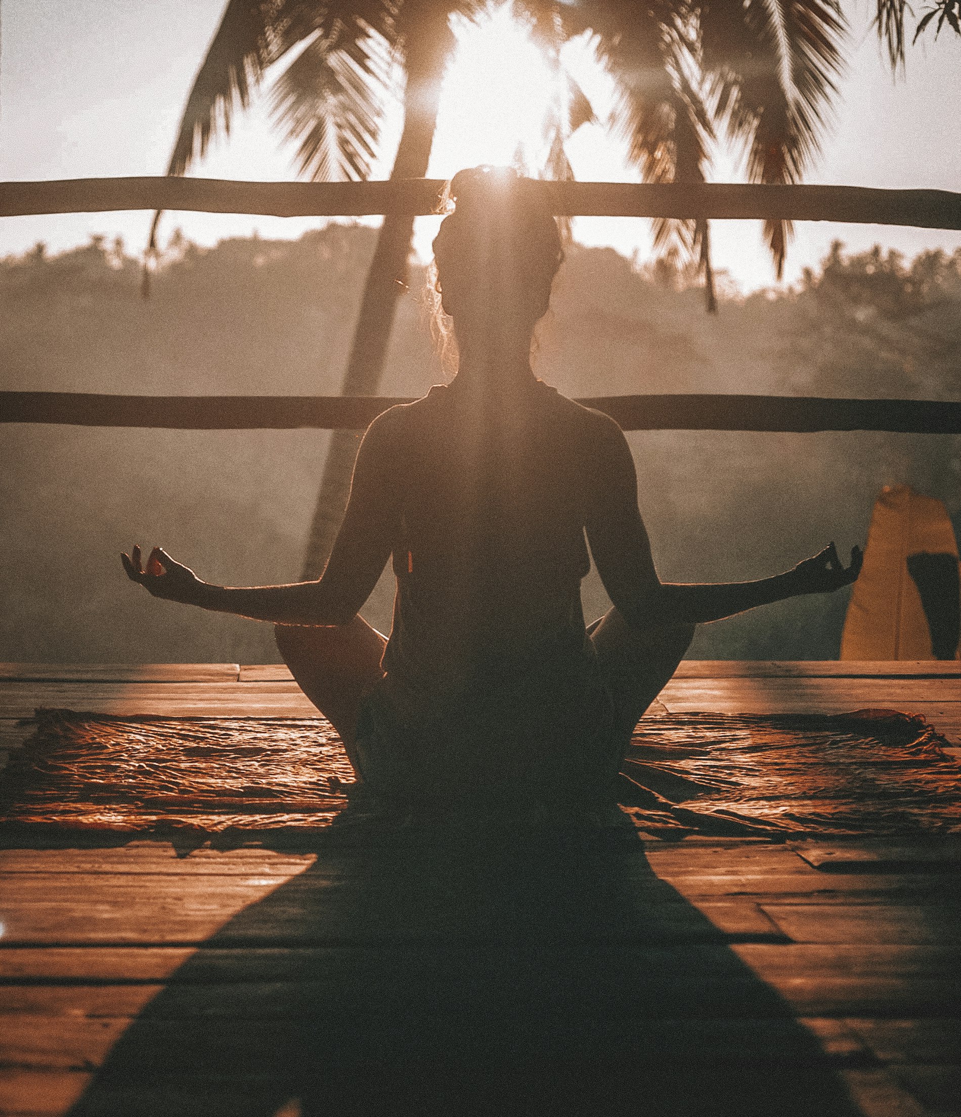 Meditation at sunrise over still water